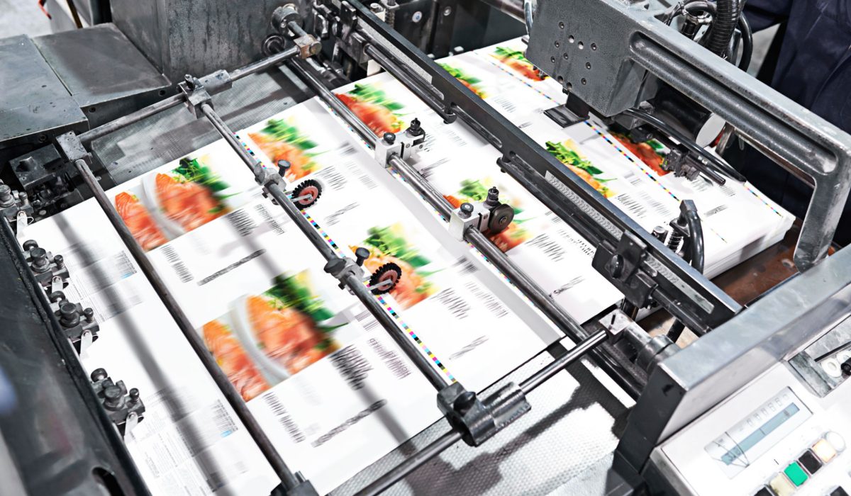 Detail shot of the workings of a printing factory assembly line. The commercial designs displayed in this image represent a simulation of a real product and have been changed or altered enough by our team of retouching and design specialists so that they are free of any copyright infringements